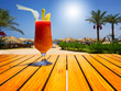 Glass of tasty juice with pipe on the table next to beach. Egypt