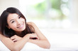 Charming woman Smile face and lying on bed