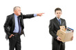 Photo: Angry boss firing a man carrying a box of personal items Angry boss firing a man carrying a box of personal items