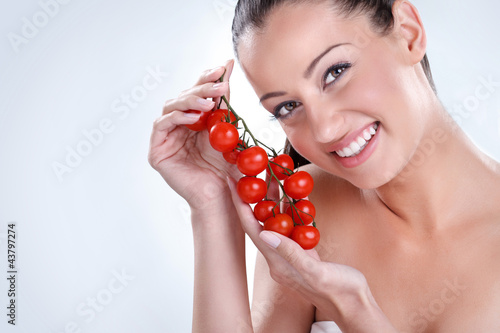 Photo: Woman with bunch of Cherry tomatoes. Woman with bunch of Cherry tomatoes.