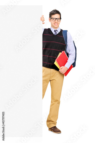 Photo: Full length portrait of a male student posing behind a panel Full length portrait of a male student posing behind a panel