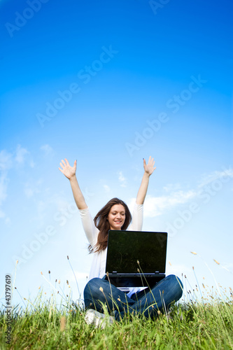 Photo: Girl using laptop outdoors Girl using laptop outdoors