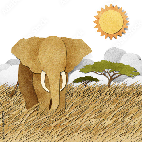 Photo: Elephant in Safari field recycled paper background Elephant in Safari field recycled paper background