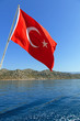Foto: Flag of Turkey against the sea and mountains Flag of Turkey against the sea and mountains
