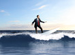 Photo: Young business person surfing on the waves Young business person surfing on the waves