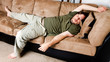 A guy flung all over the couch
