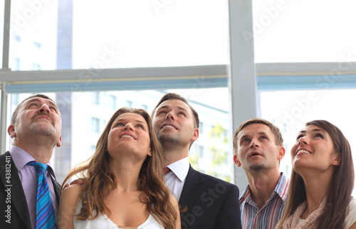 Photo: Group of executives looking up at something Group of executives looking up at something