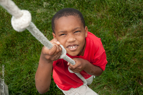 Photo: Boy climbing a rope Boy climbing a rope