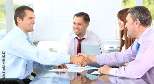 Photo: Business people shaking hands, finishing up a meeting Business people shaking hands, finishing up a meeting