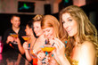 People in club or bar drinking cocktails