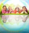 Foto: Children laying on grass near water. Family and friends picnic i Children laying on grass near water. Family and friends picnic i