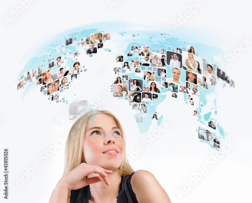 Photo: Young woman looking at virtual worldmap with photo of different Young woman looking at virtual worldmap with photo of different