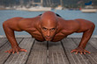 Photo: fit healthy strong man doing press ups outdoors. fit healthy strong man doing press ups outdoors.