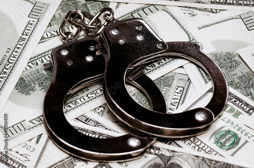 Photo: Dollars and handcuffs Dollars and handcuffs