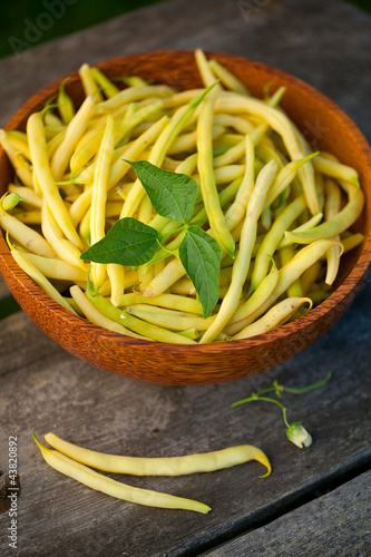 Photo: yellow kidney beans in a bowl on wooden table yellow kidney beans in a bowl on wooden table