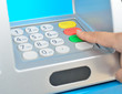 Finger pressing enter on ATM keyboard