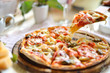 Original Italian seafood pizza sliced on wood dish