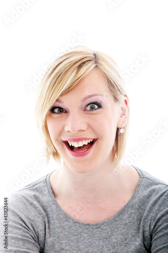 Photo: Exuberant young woman with wide beaming smile Exuberant young woman with wide beaming smile