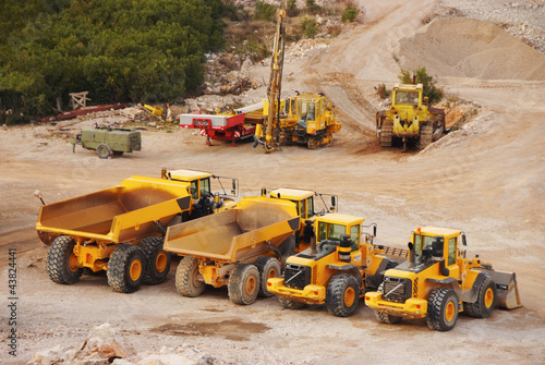 Photo: Large lorry trucks and tractors in a quarry Large lorry trucks and tractors in a quarry