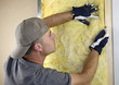Photo: Worker installing fiberglass insulation Worker installing fiberglass insulation