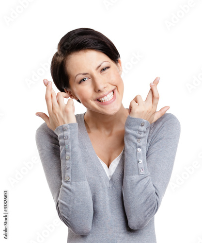 Foto: Young woman shows crossed fingers, isolated on white Young woman shows crossed fingers, isolated on white