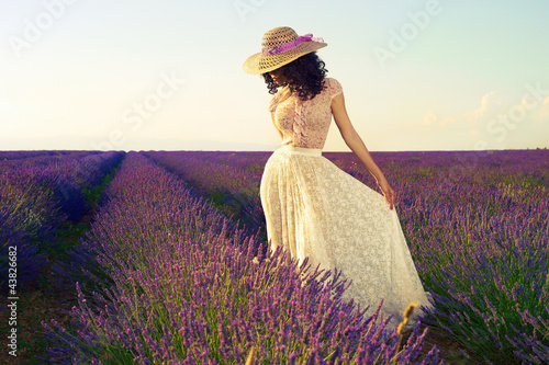 Photo: Romantic woman in fairy lavender fields Romantic woman in fairy lavender fields