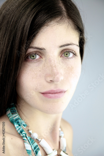 Photo: Beautiful serious woman with gorgeous eyes and freckles Beautiful serious woman with gorgeous eyes and freckles