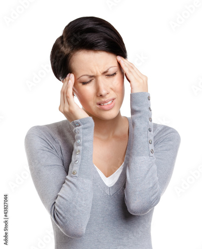 Photo: Girl has a headache, isolated on white Girl has a headache, isolated on white