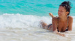 Attractive woman lying in shallow water