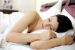 Photo: woman sleeping in the morning in beautiful pink bed woman sleeping in the morning in beautiful pink bed