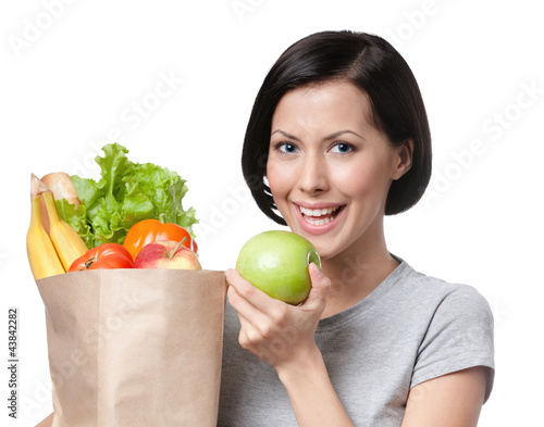 Foto: Portrait of girl eating an apple, isolated, white background Portrait of girl eating an apple, isolated, white background