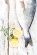 Seafood. Fish with lemon and herbs, top view.