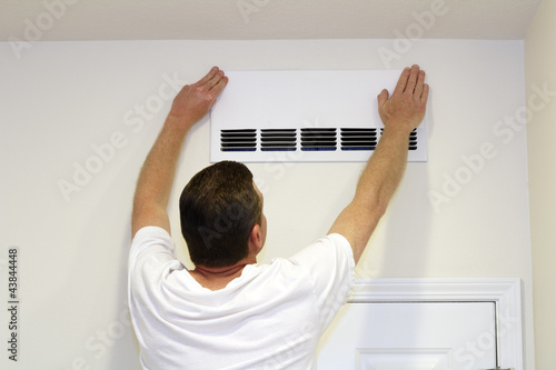 Photo: Man Covering Air Vent Man Covering Air Vent