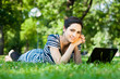 Beautiful young woman  using her laptop outdoors