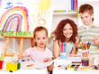 Child painting at easel.