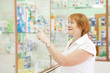woman chooses drugs at pharmacy