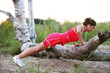 Photo: Woman doing push ups on the broken tree Woman doing push ups on the broken tree