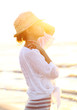 Photo: Beautiful woman wearing a hat in sunset light Beautiful woman wearing a hat in sunset light