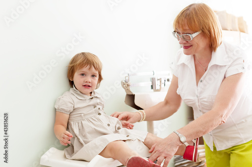 Photo: pediatrician weighs the baby pediatrician weighs the baby