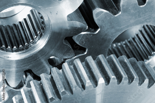 Photo: gear wheels and titanium, blue toning concept gear wheels and titanium, blue toning concept