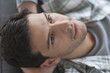 Man lying on a couch and thinking