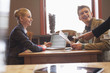 Waiter giving tea to a couple in a restaurant