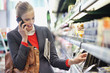 Woman in a supermarket talking on a mobile phone