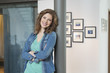 Happy woman leaning against a column