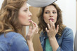 Photo : Woman examining her sore lips Woman examining her sore lips