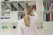 Woman taking out a book from shelf