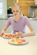 Woman with cakes at dining table