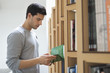 Man choosing a book from a bookshelf