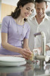 Woman washing utensils in the kitchen
