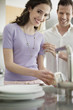 Woman washing utensils in the kitchen